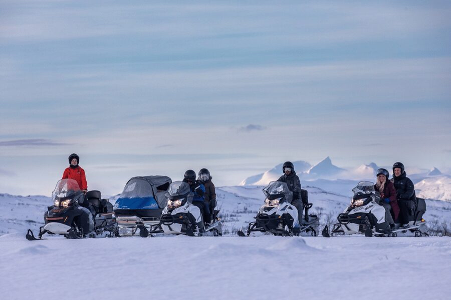 Abisko: Great Outback Snowmobile Tour with Lake Abiskojaure - Getting comfortable on a shared snowmobile