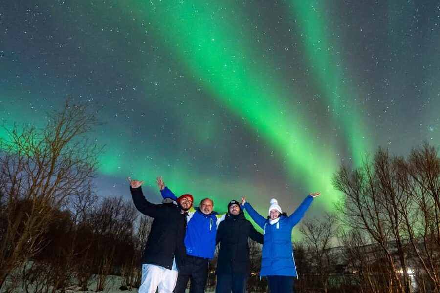 From Tromsø: Aurora Minibus Chase with Portrait and Hot Meal - Waiting beside a lake, beach, or frozen view