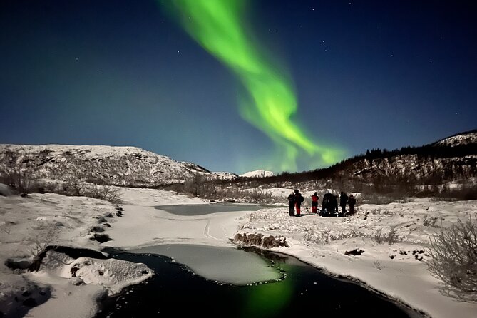 Tromsø: Northern Lights by Minibus - Free Photos and Warm Dinner - Standing in the snow with thermal overalls